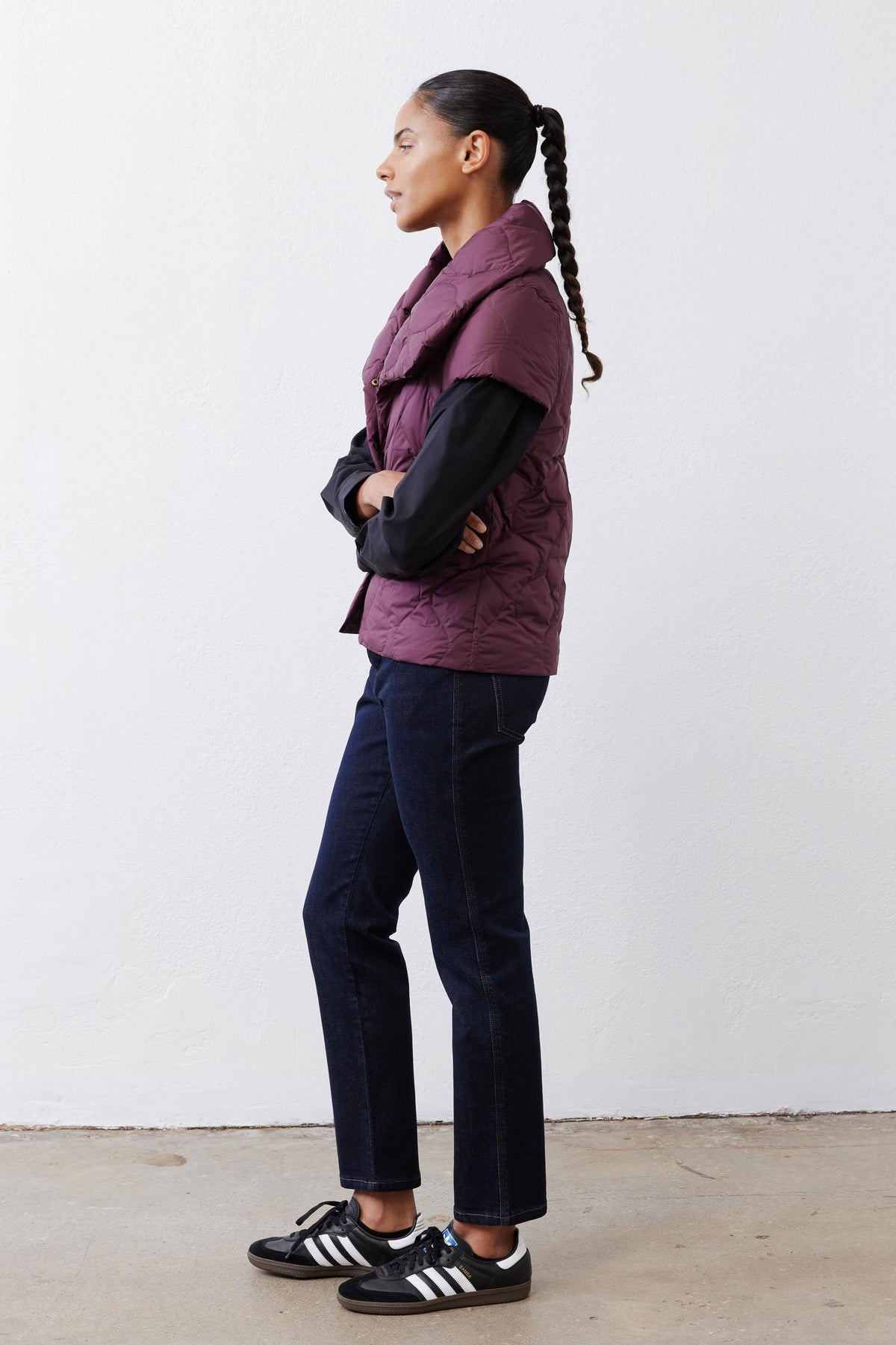 Deep plum quilted down vest, sleeveless design with stand collar