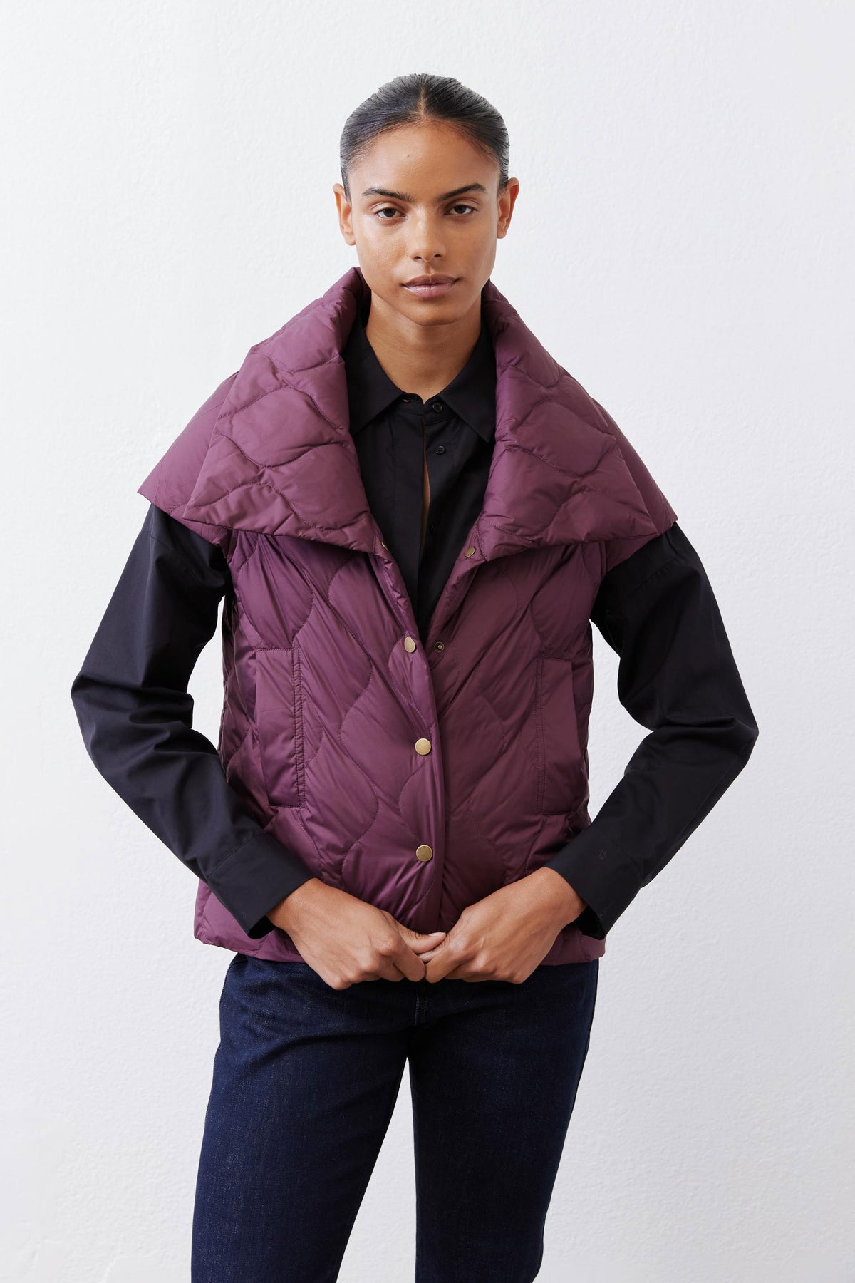 Deep plum quilted down vest front view with stand collar and snap placket
