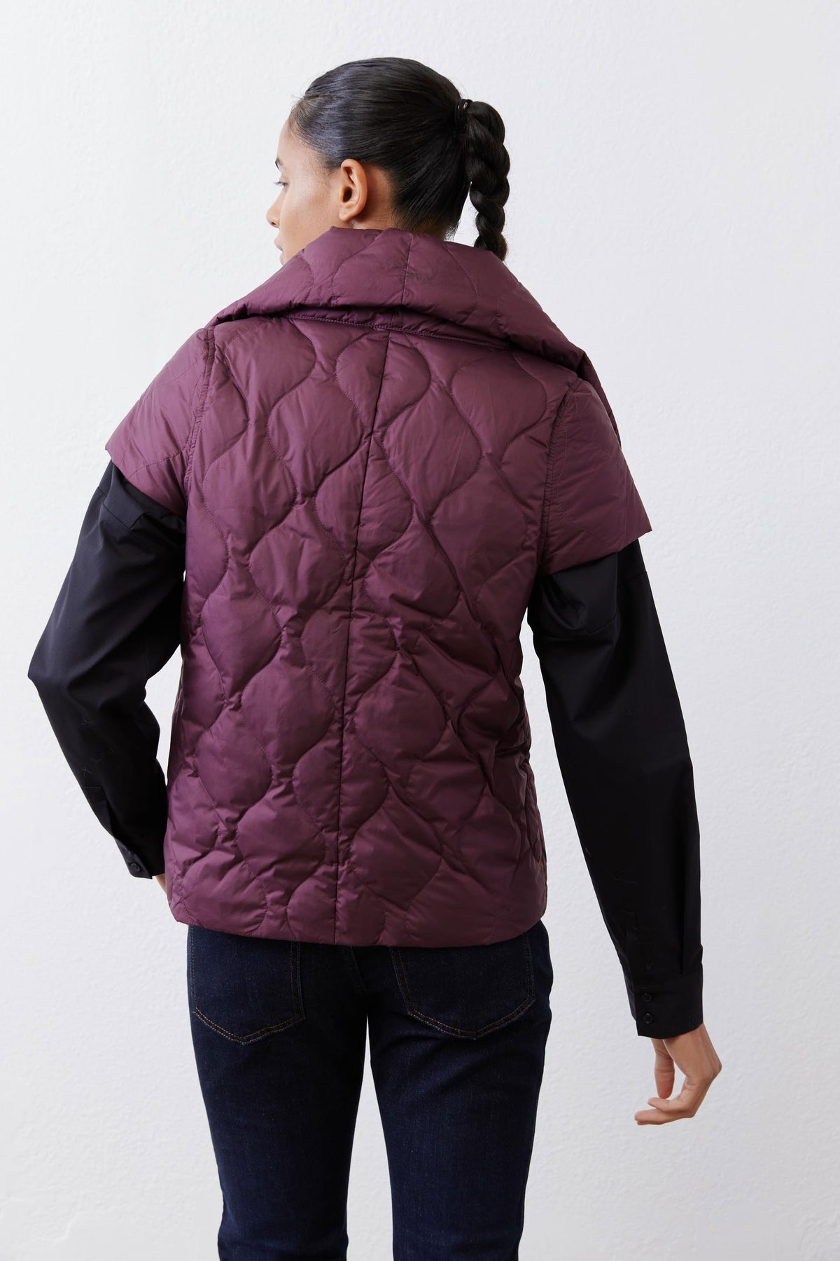 Deep plum quilted down vest back view with stand collar and curved yoke quilting