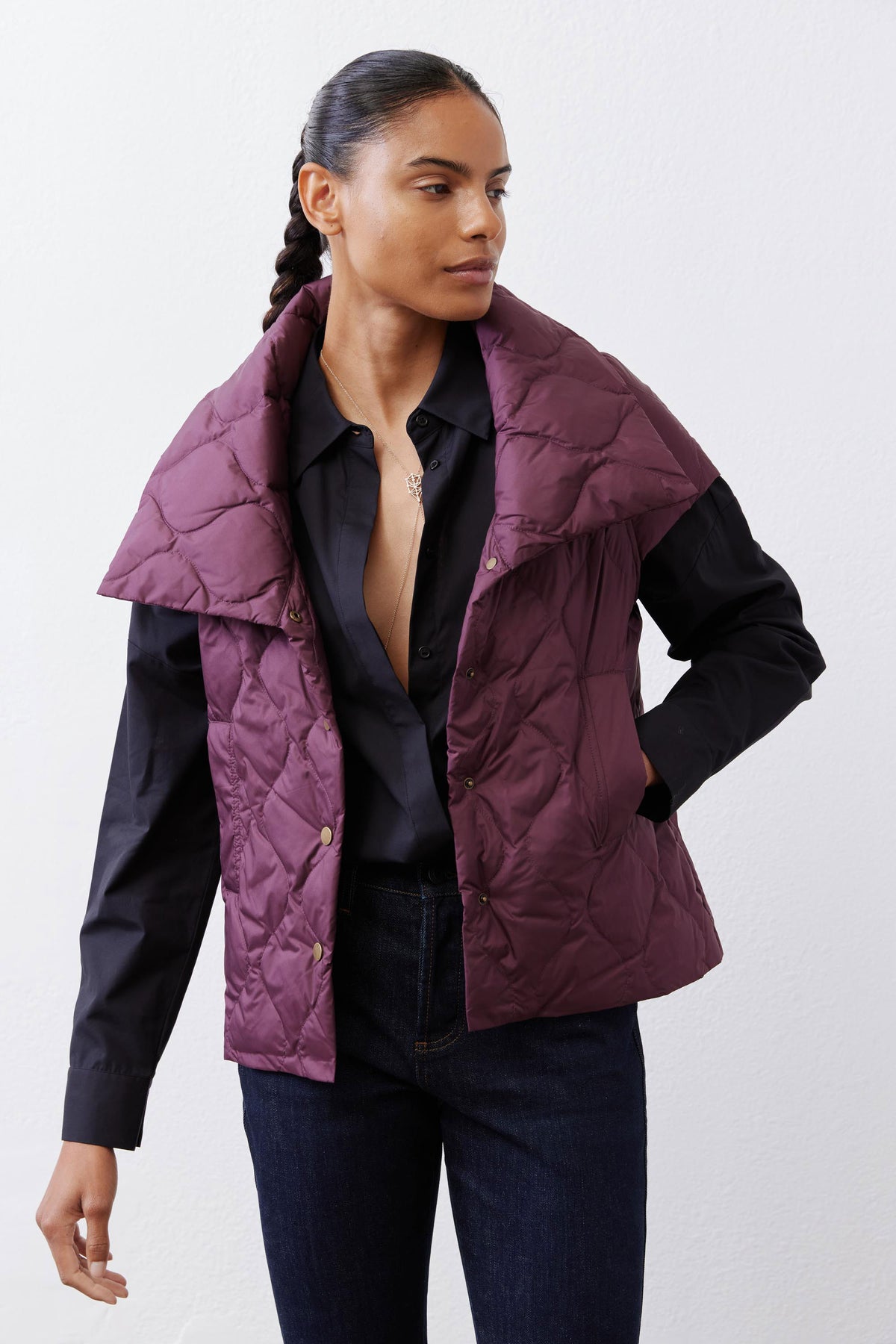 Deep plum quilted down vest close-up with stand collar and snap buttons