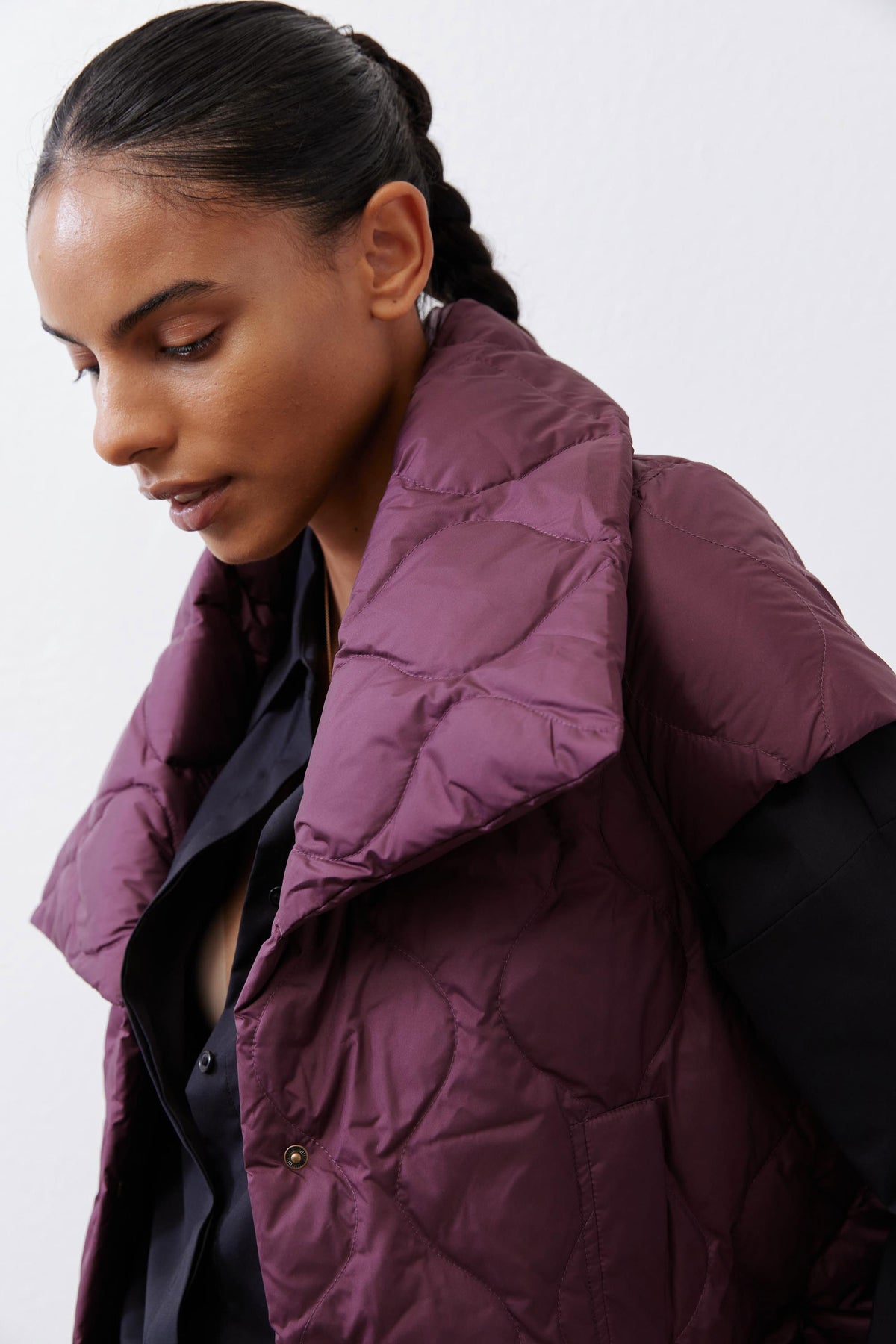 Deep plum quilted down vest detail view with stand collar and buttoned placket