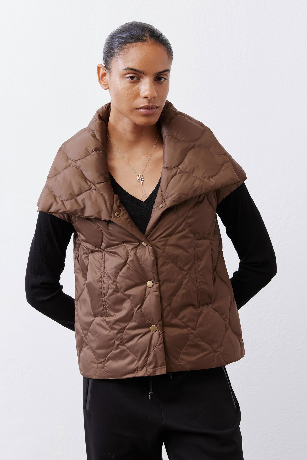 Coffee brown quilted down vest with button-front placket and two chest pockets