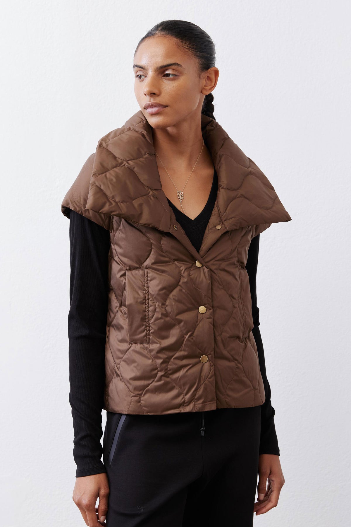 Coffee brown quilted down vest with button-front closure and stand collar, close view