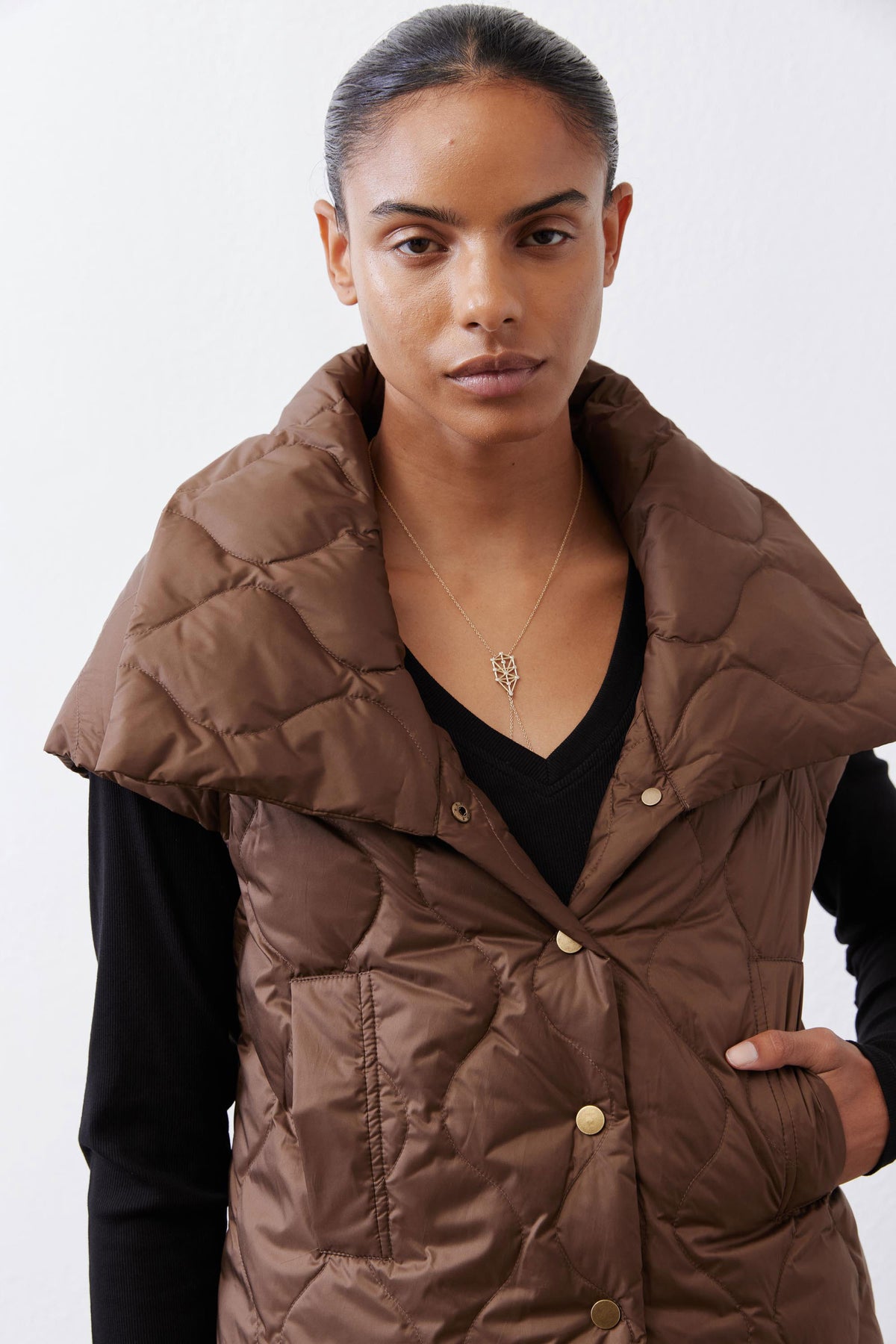 Coffee brown quilted down vest with stand collar, button-front and chest pocket detail