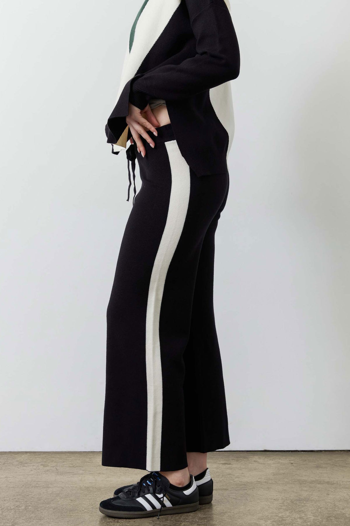 Black lounge pants with vertical ivory stripe, wide leg and drawstring waistband
