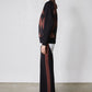 Black wide-leg lounge pants with chestnut vertical stripe