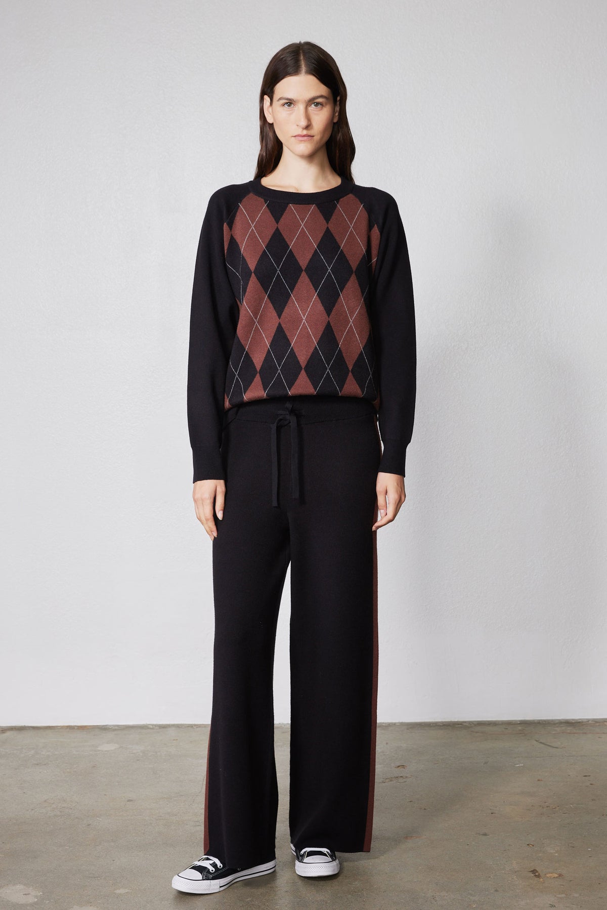 Black lounge pants with wide legs and chestnut stripe; drawstring waist