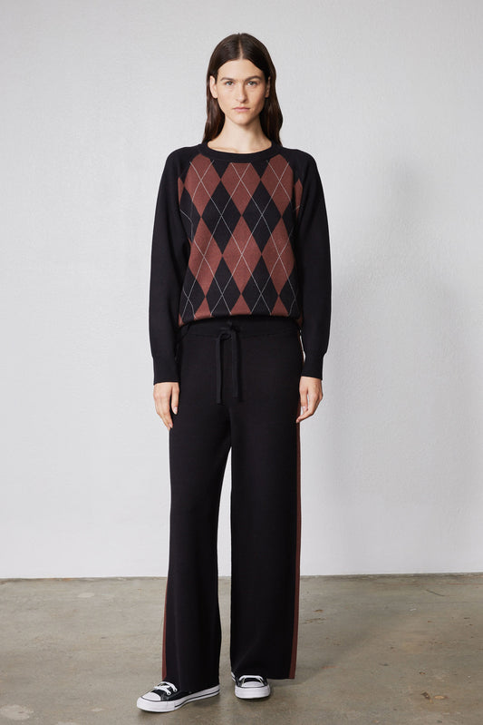 Black lounge pants with wide legs and chestnut stripe; drawstring waist