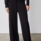 Black lounge pants with chestnut side stripe and wide straight legs
