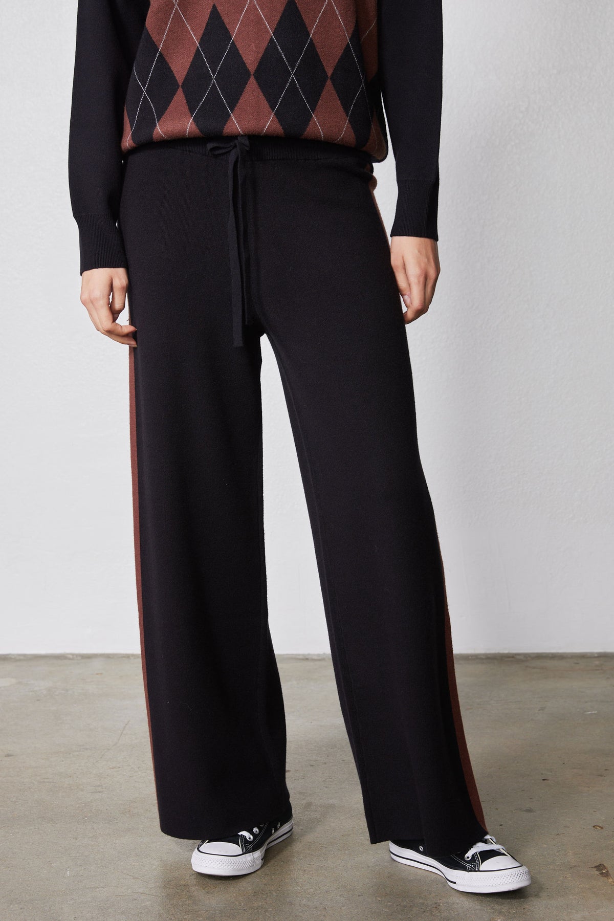 Black lounge pants with chestnut side stripe and wide straight legs