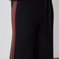 Black lounge pants with chestnut side stripe and elastic waistband