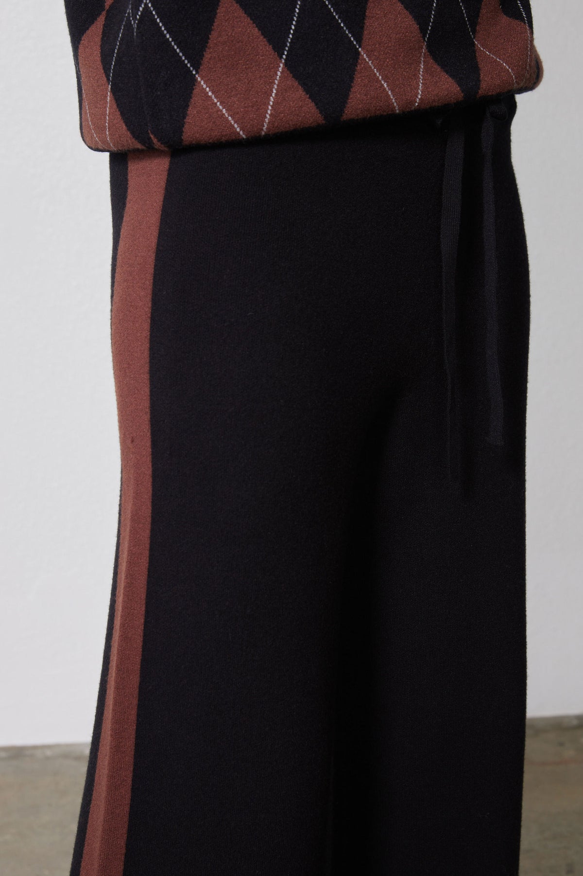 Black lounge pants with chestnut side stripe and elastic waistband