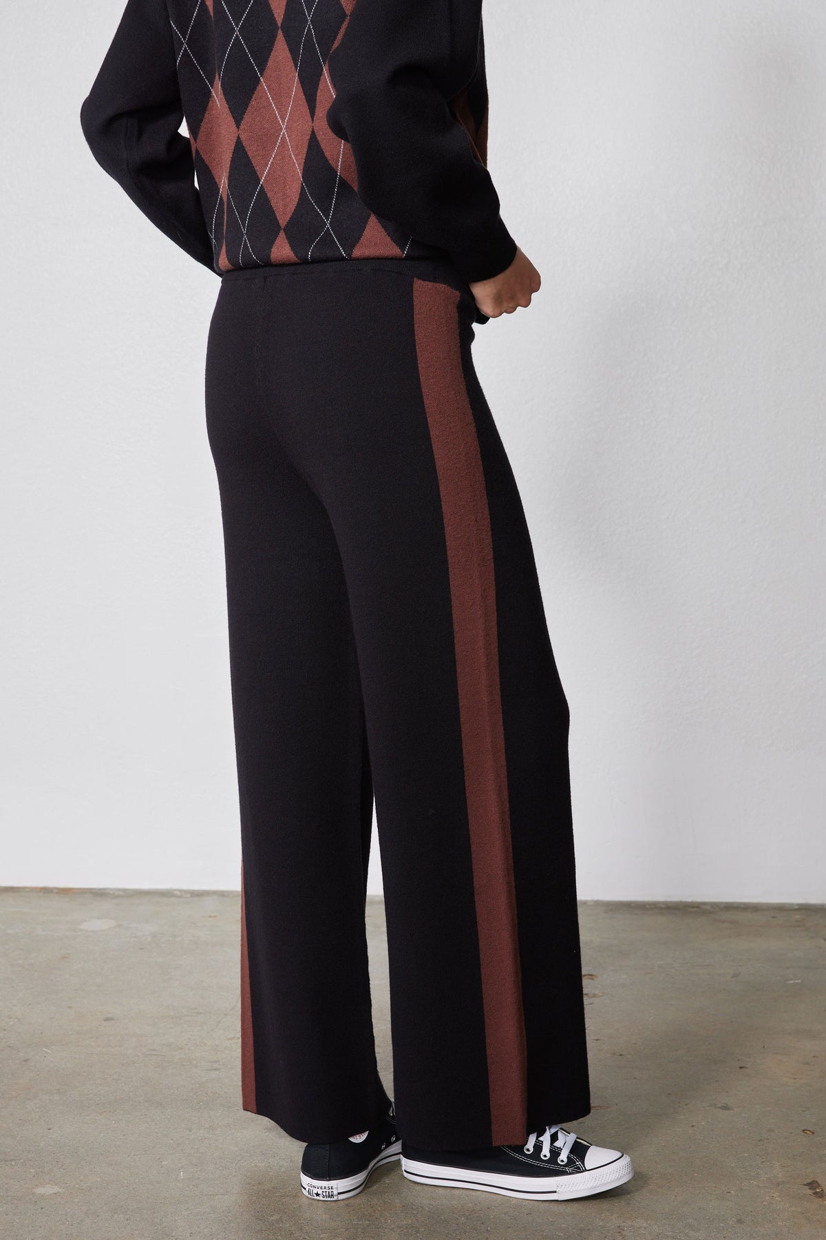 Black lounge pants with chestnut side stripe and flared wide hem