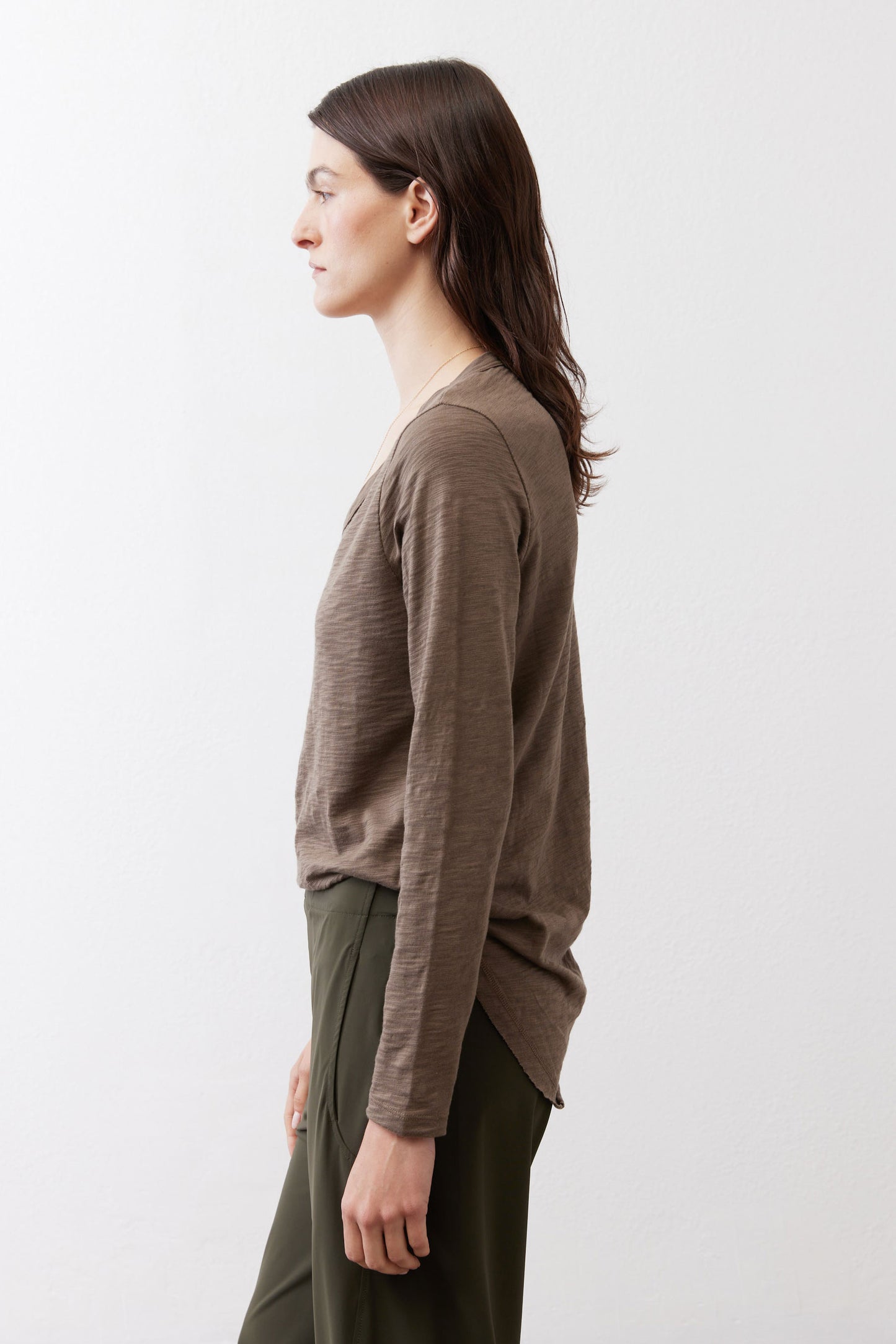 Brown long-sleeve V-neck top, side view