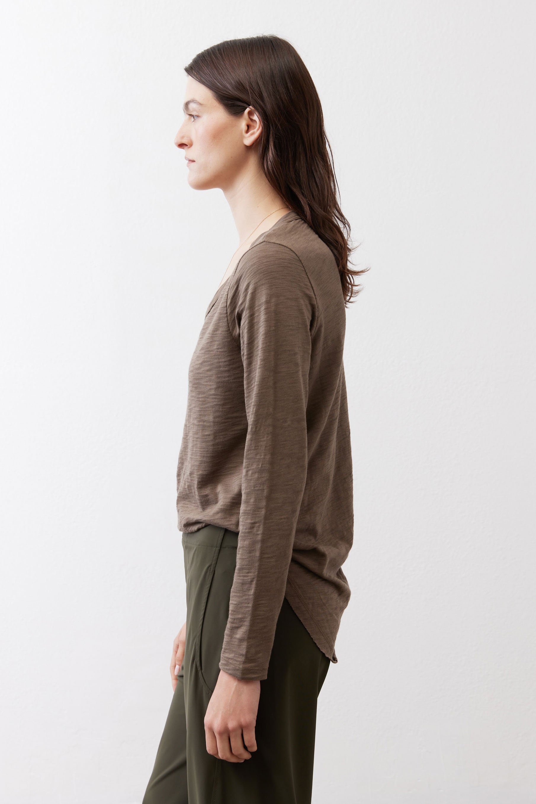 Brown long-sleeve V-neck top, side view