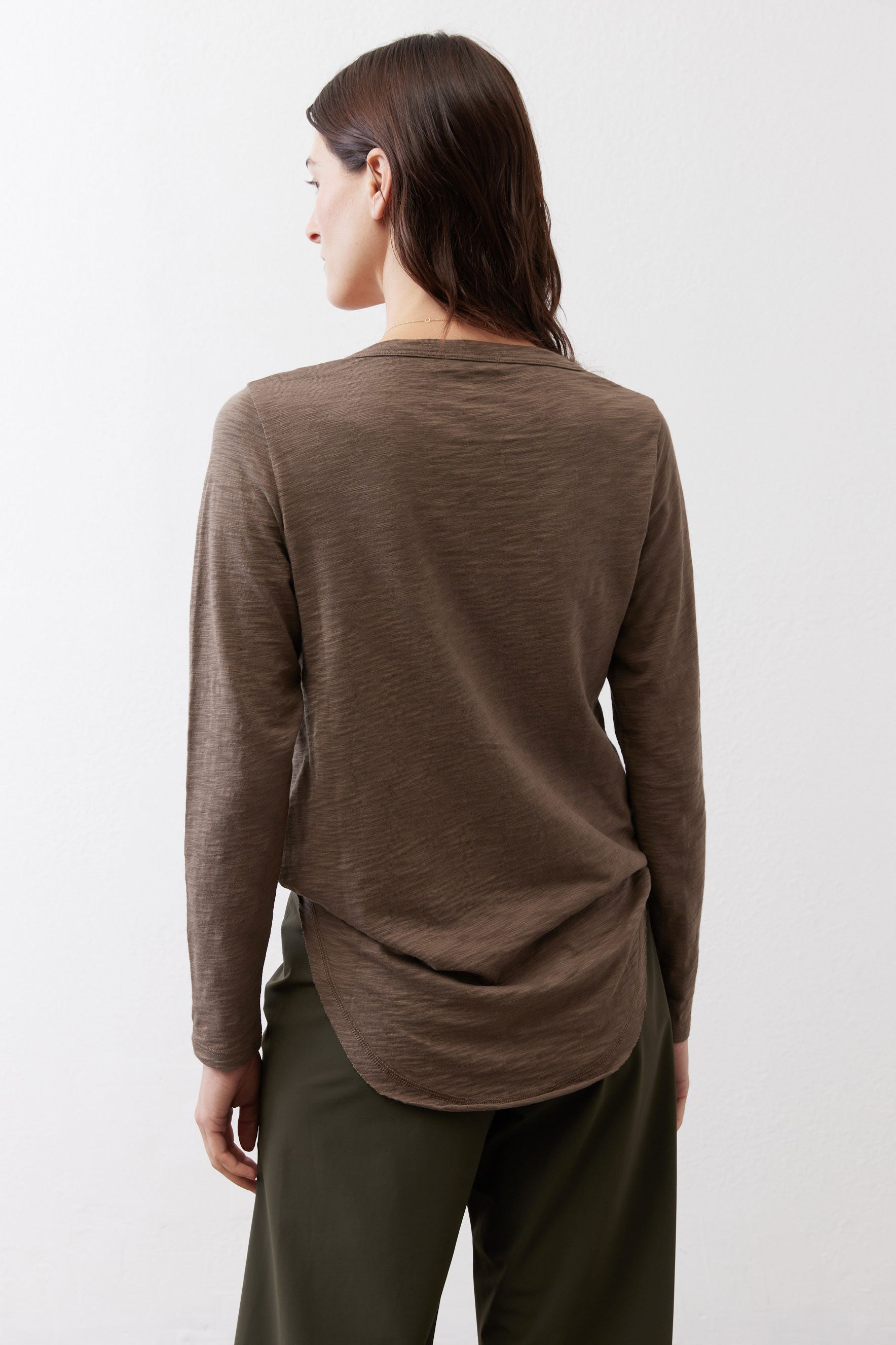 Brown V-neck long-sleeve top, back view with draped hem