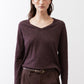 Coffee-brown V-neck long-sleeve top with soft folds and extended sleeves