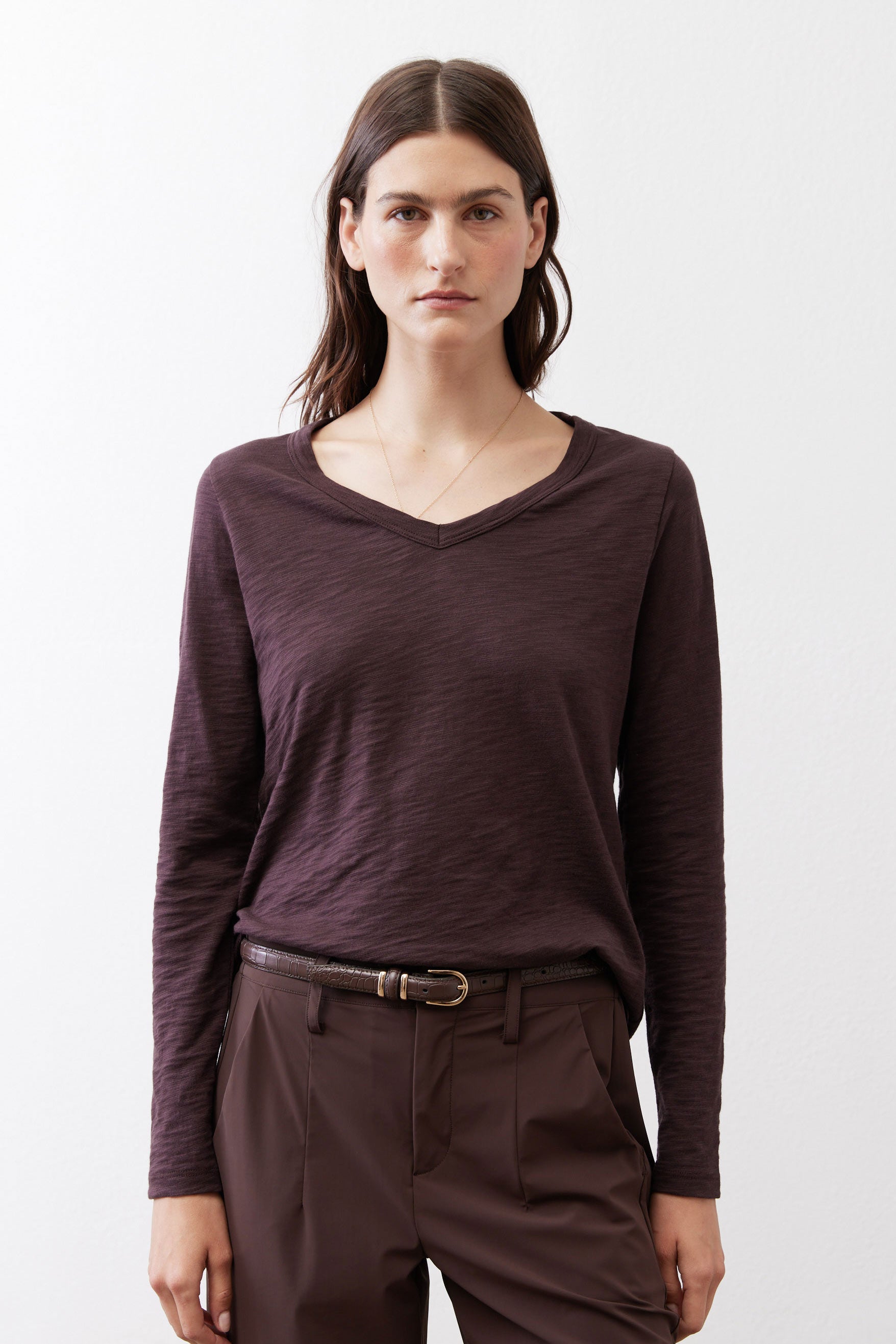Coffee-brown V-neck long-sleeve top with soft folds and extended sleeves