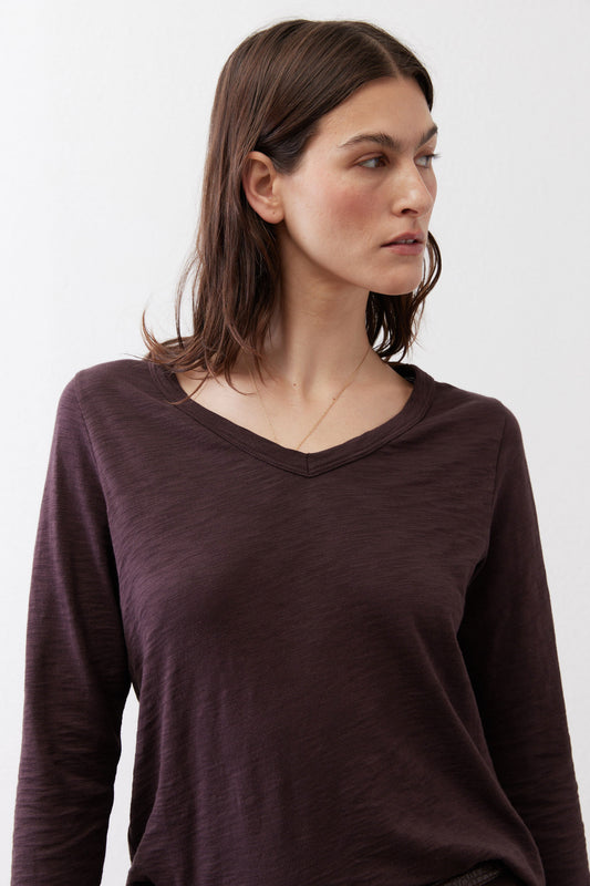Coffee-brown V-neck swing top on model with long sleeves, close-up