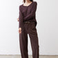 Coffee-brown V-neck long-sleeve top with relaxed drape and V-shaped neckline