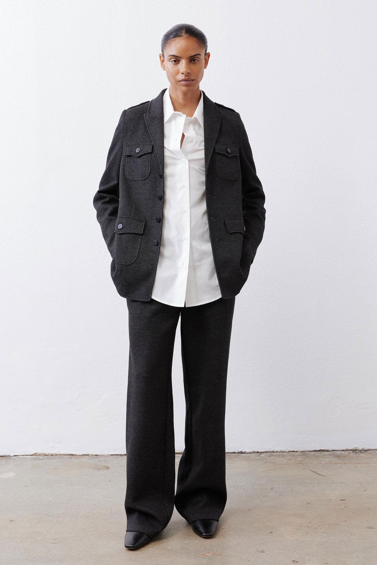 Charcoal herringbone blazer with flap pockets and button front