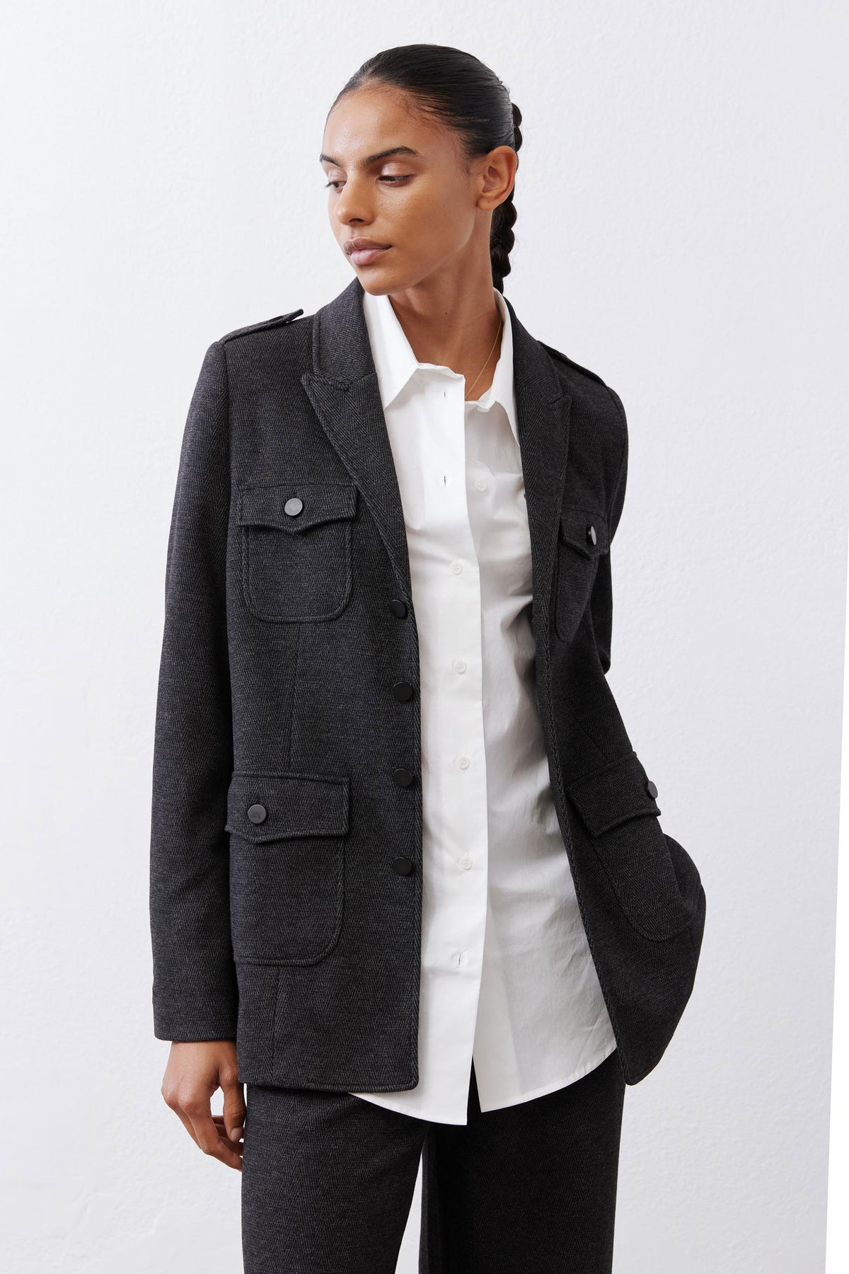 Charcoal herringbone blazer with flap pockets and white shirt underneath