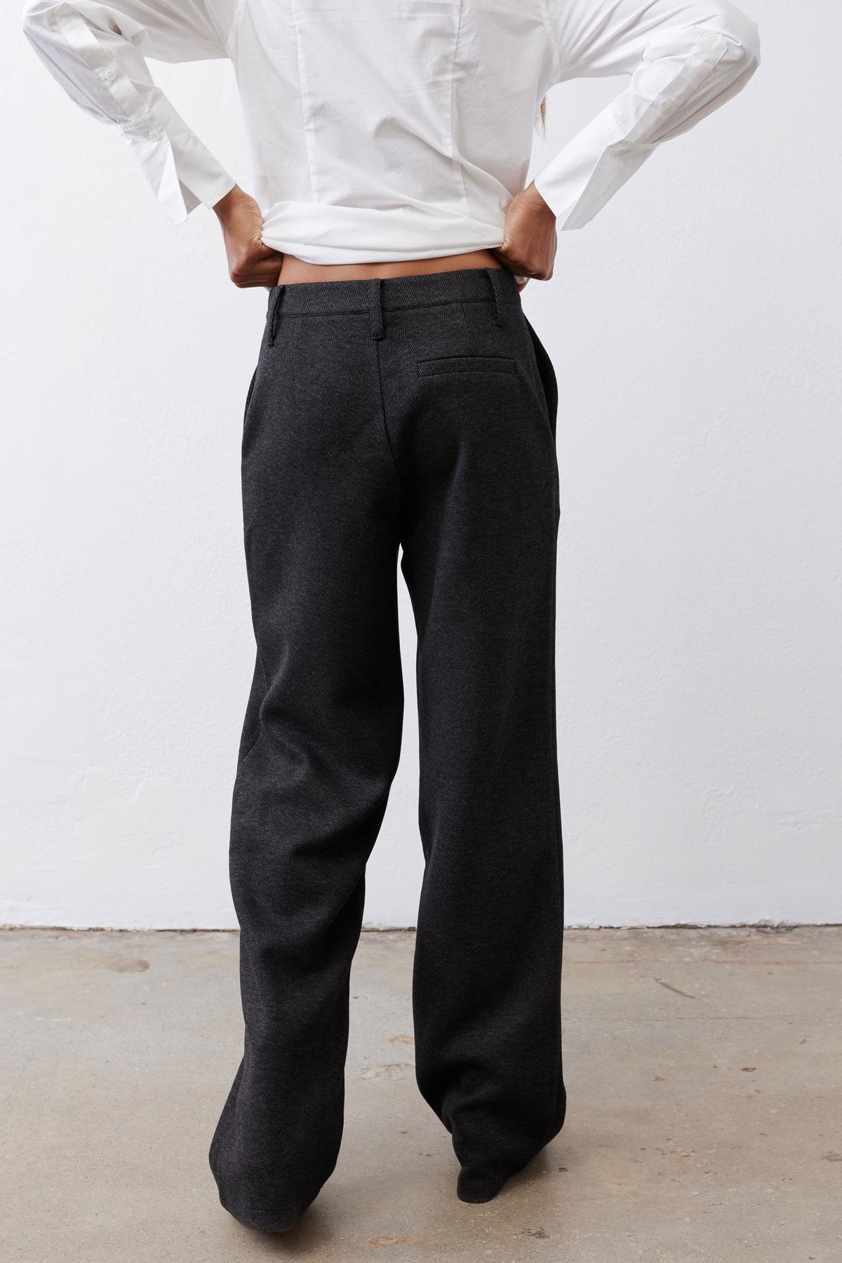 Charcoal straight-leg tailored pants, back view with belt loops and center seam