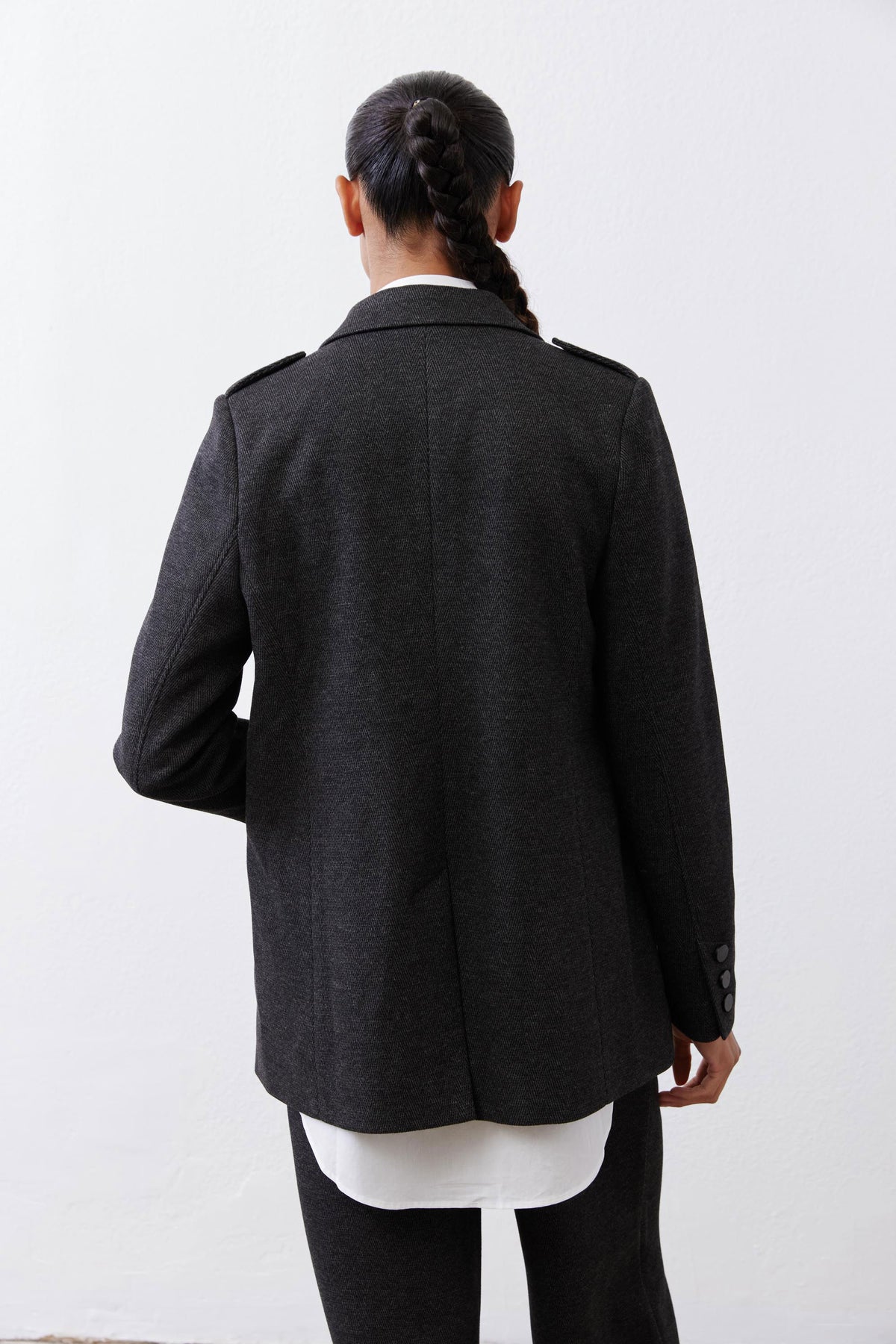 Charcoal herringbone blazer back view with single-button cuff