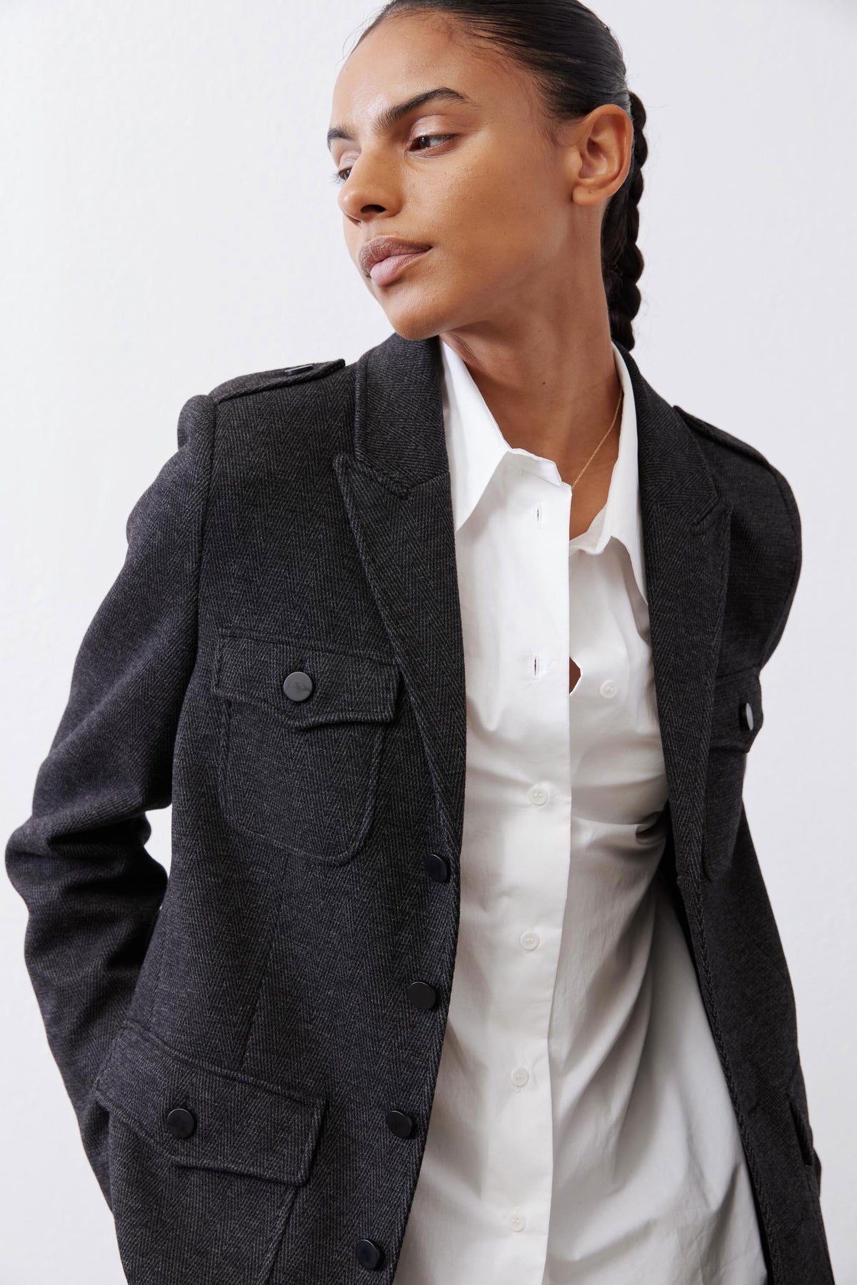 Charcoal herringbone blazer with flap pocket and buttoned front