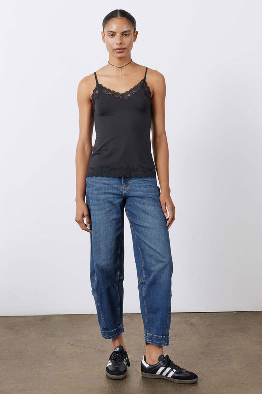 Black lace cami top with spaghetti straps over blue jeans, straight hem