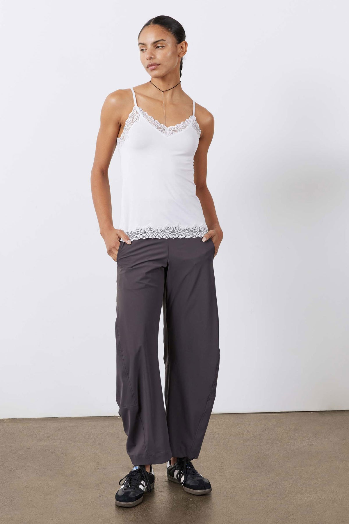 White lace-trim cami with thin straps and scalloped hem, full-body view