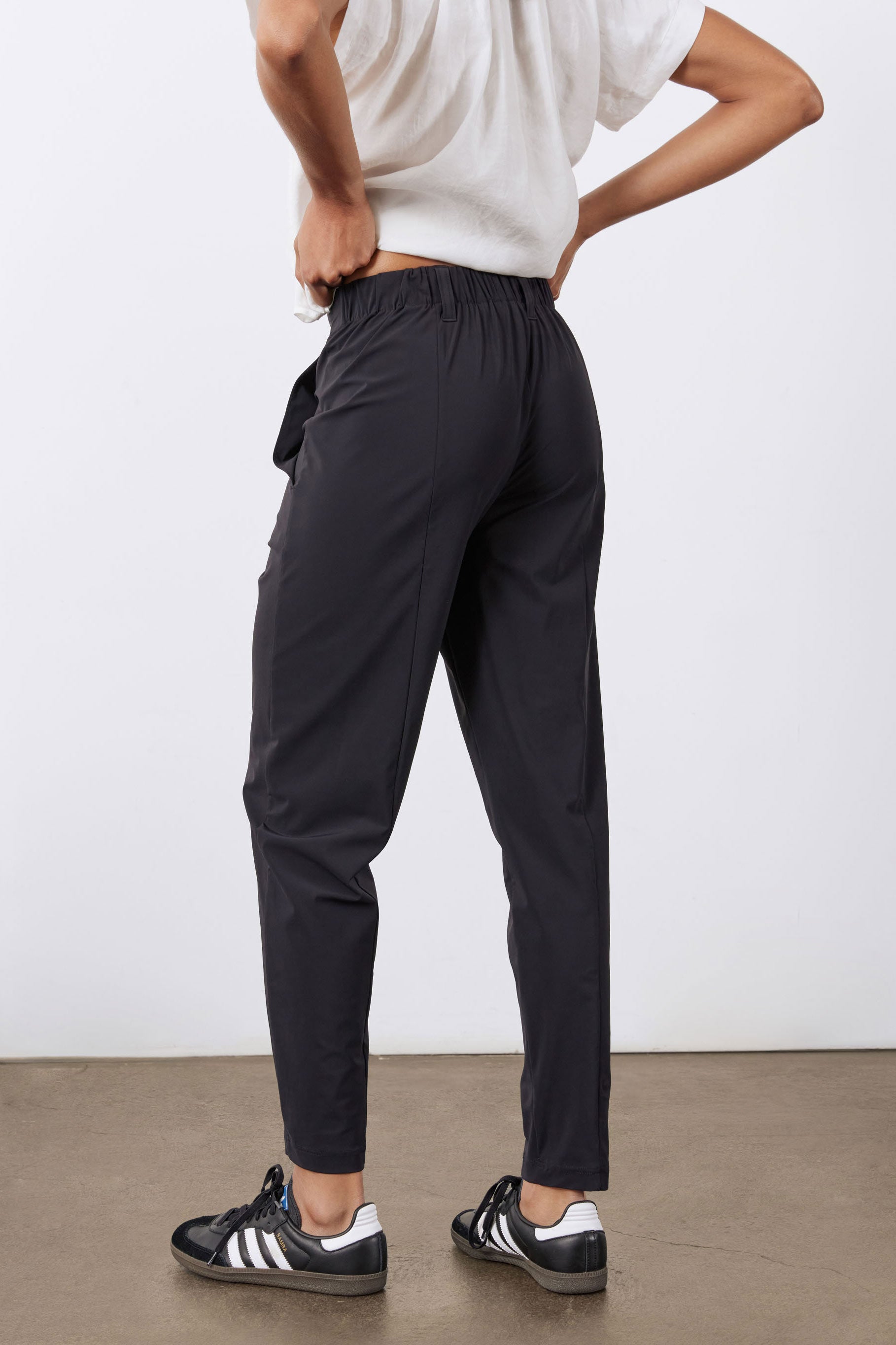 Black not-too-tapered pants with pleats and tapered leg opening