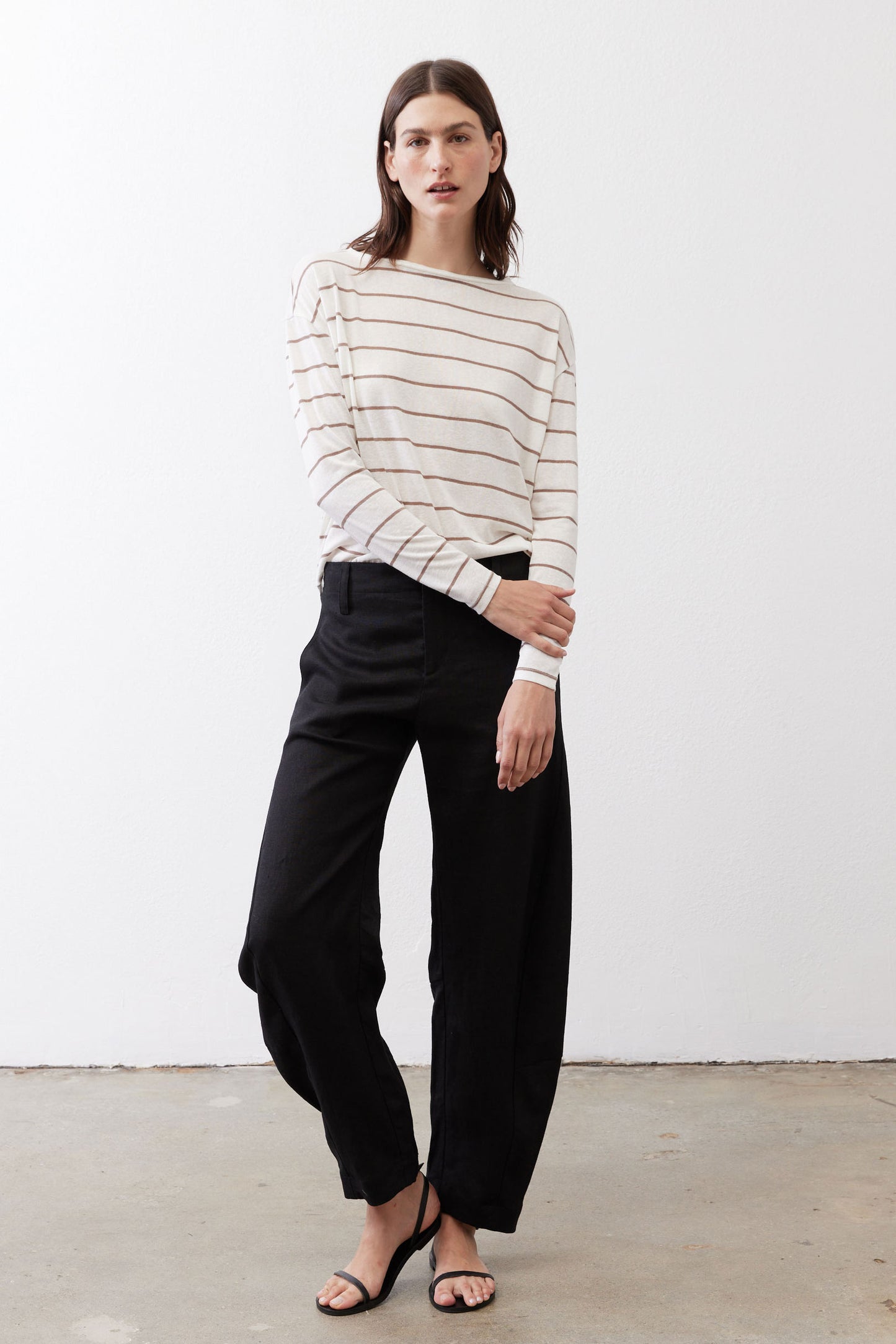 Striped long-sleeve top with rounded neckline and buttoned back opening
