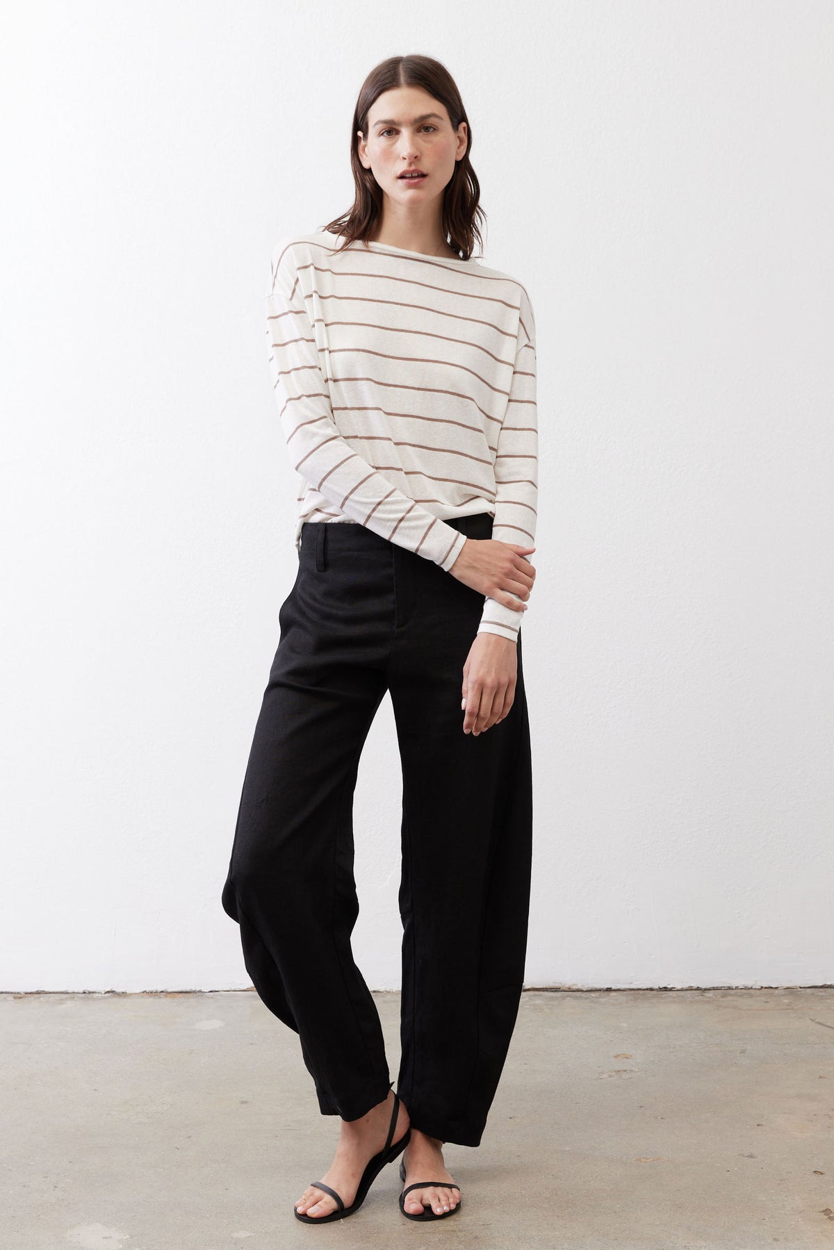 Striped long-sleeve top in off-white with tan and red horizontal lines, button-back.