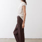 Striped short-sleeve T-shirt with off-white fabric and brown horizontal stripes, tucked.