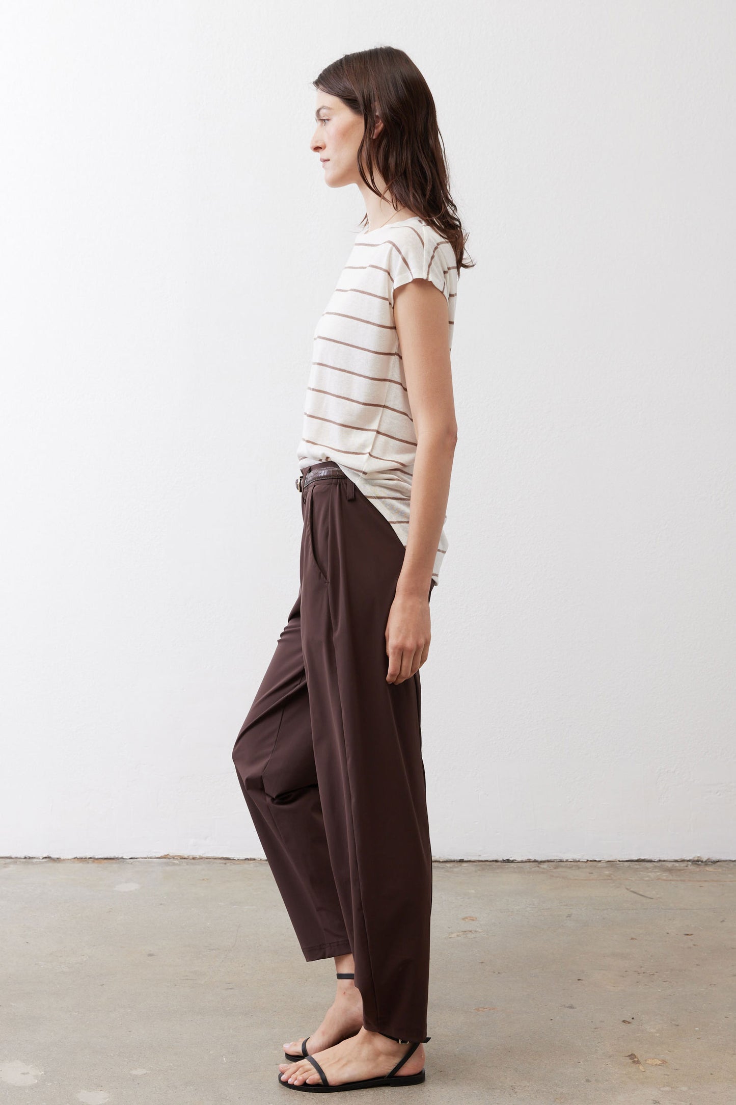 Striped short-sleeve T-shirt with off-white fabric and brown horizontal stripes, tucked.
