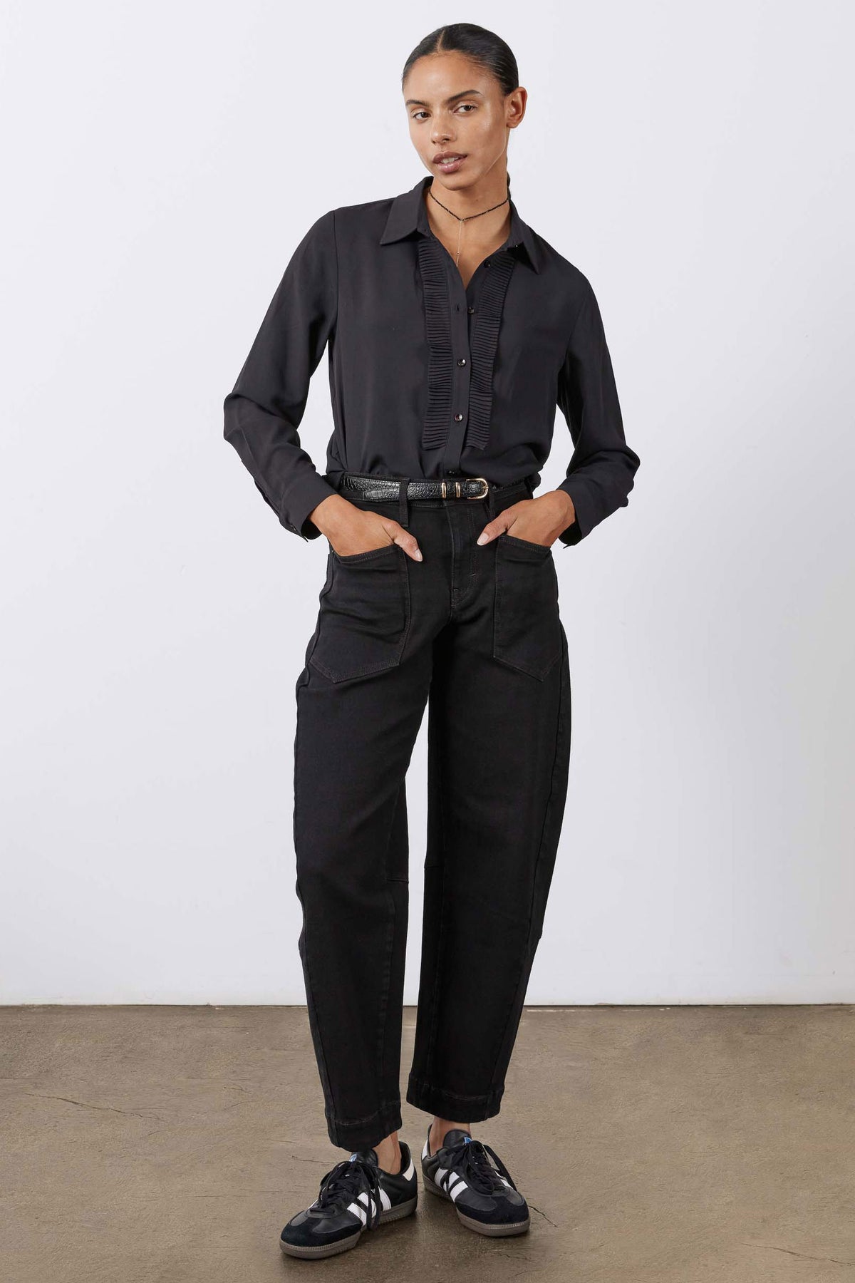 Black button-up blouse with point collar and ribbed front placket, full-length view