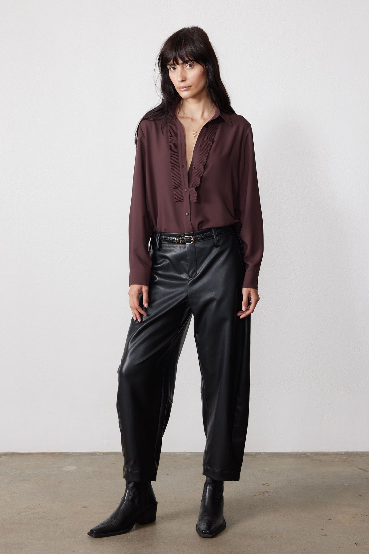 Dark brown button-up blouse with long sleeves and textured ruffle front