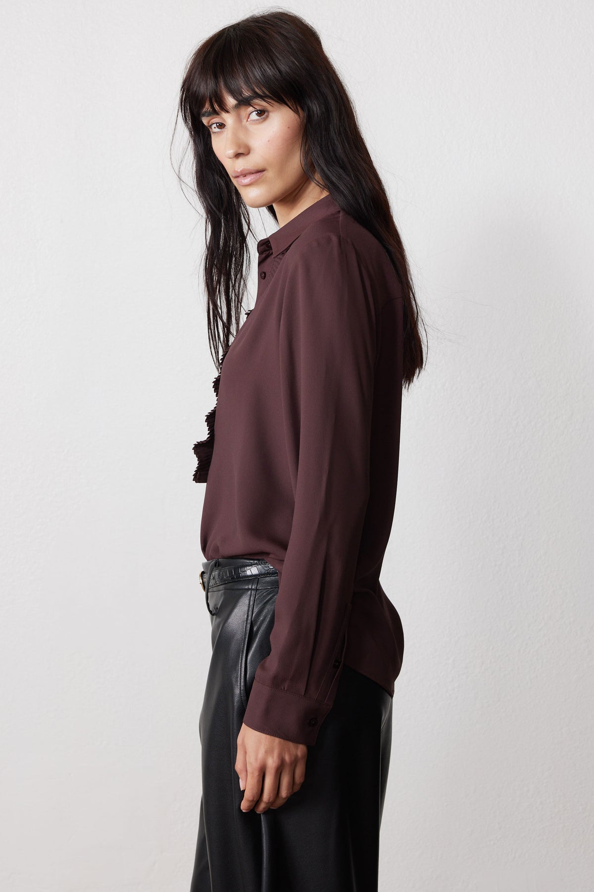 Dark brown button blouse with long sleeves and ruffle trim at neckline