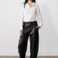 Off-white button-front blouse with pointed collar and long sleeves, textured front placket