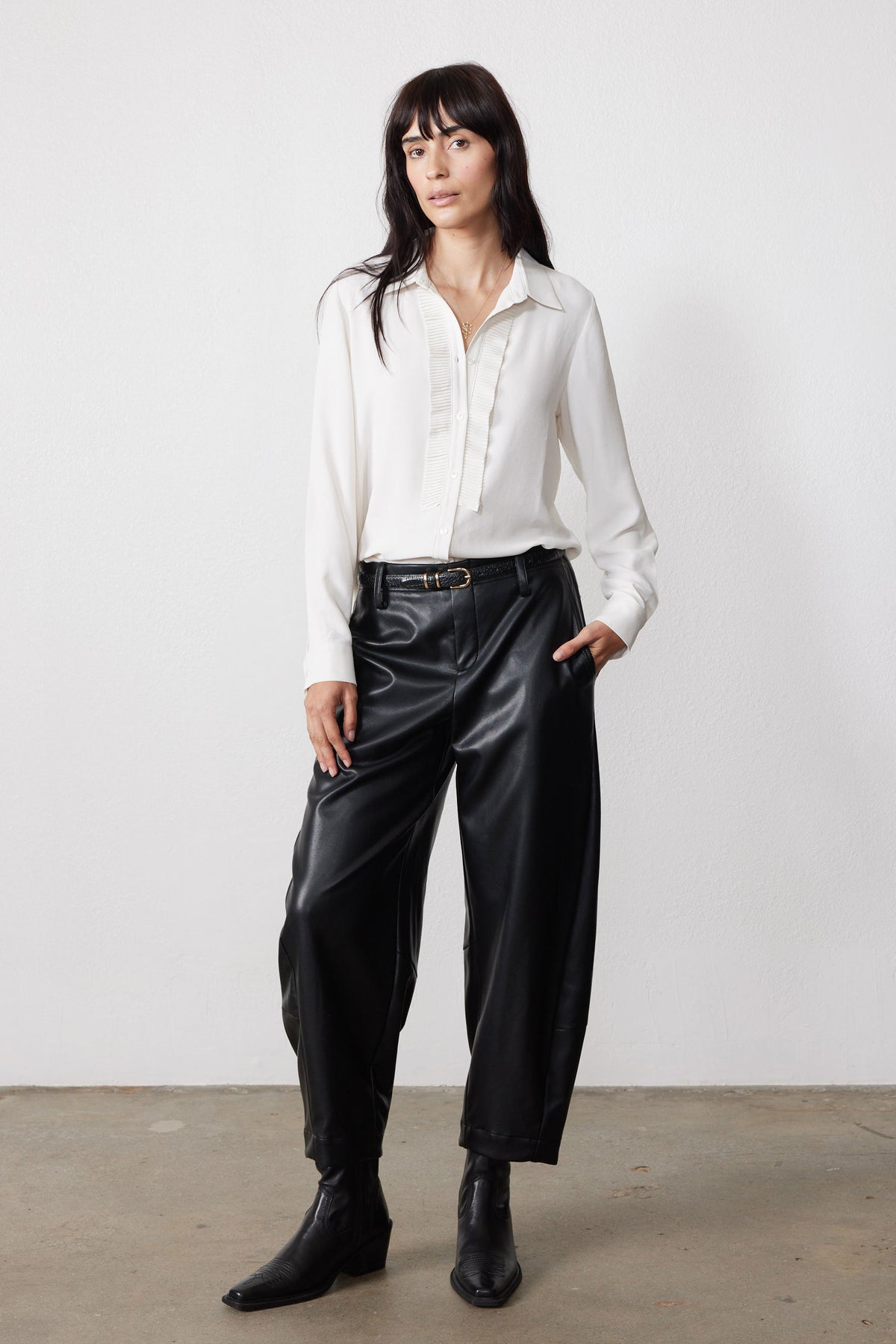 Off-white button-front blouse with pointed collar and long sleeves, textured front placket