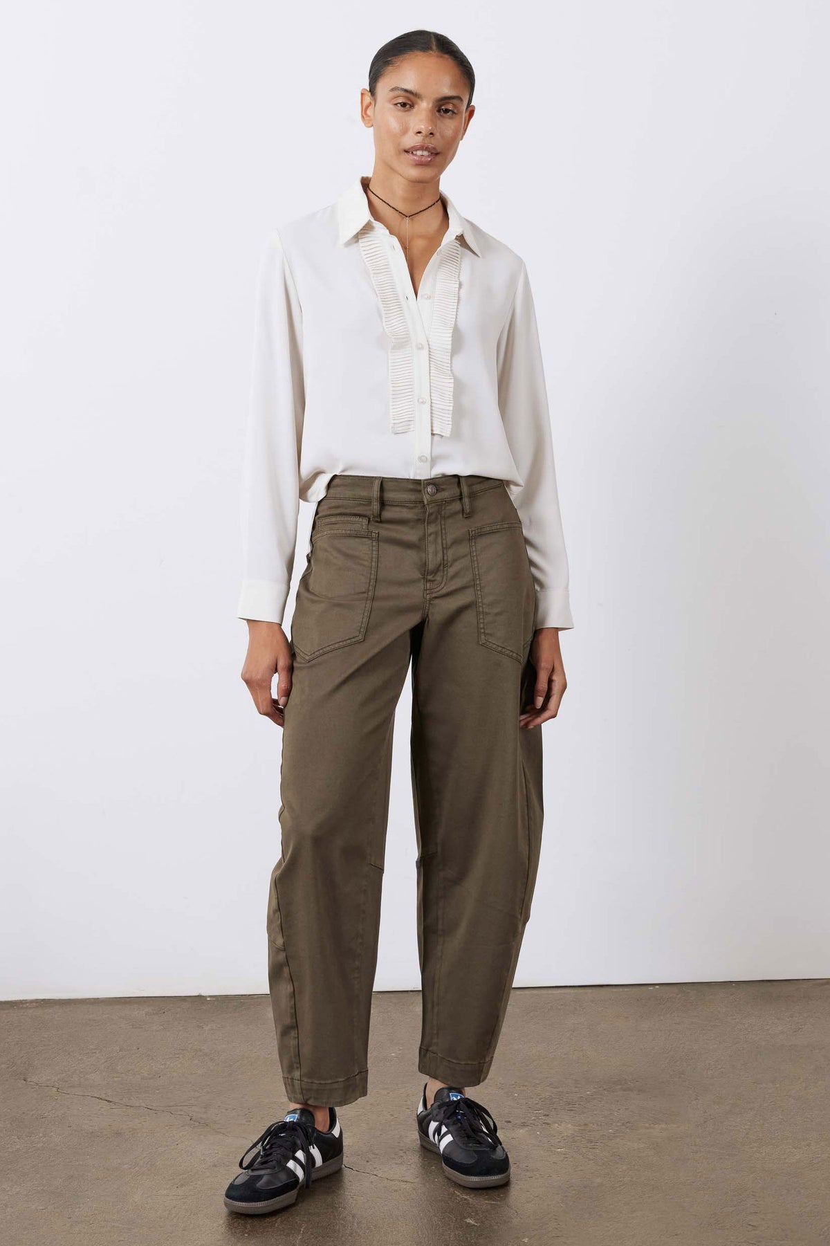 Off-white button-up blouse with pointed collar and long sleeves, pleated front detail