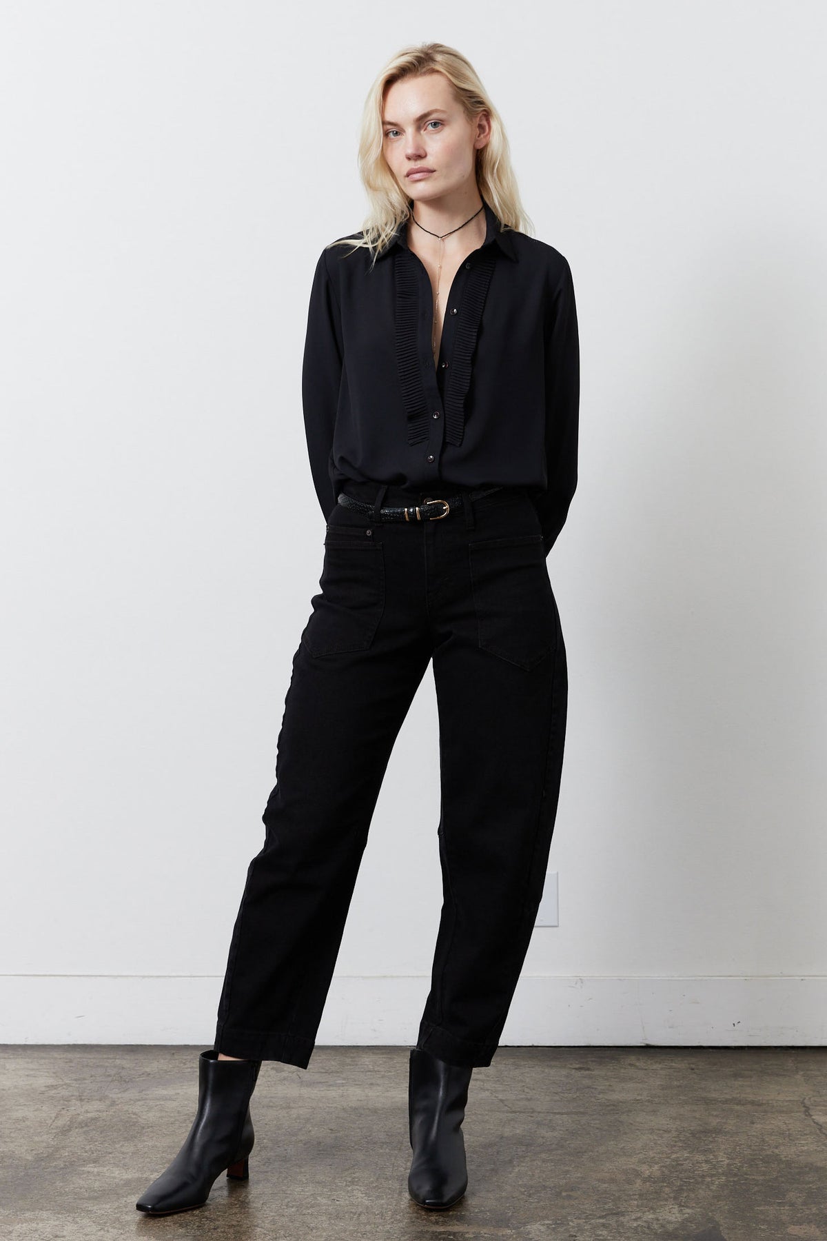 Black button-up blouse with point collar, long sleeves, ribbed front placket