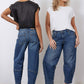 Indigo barrel-leg jeans shown from back and side, rolled cuffs and patch pockets