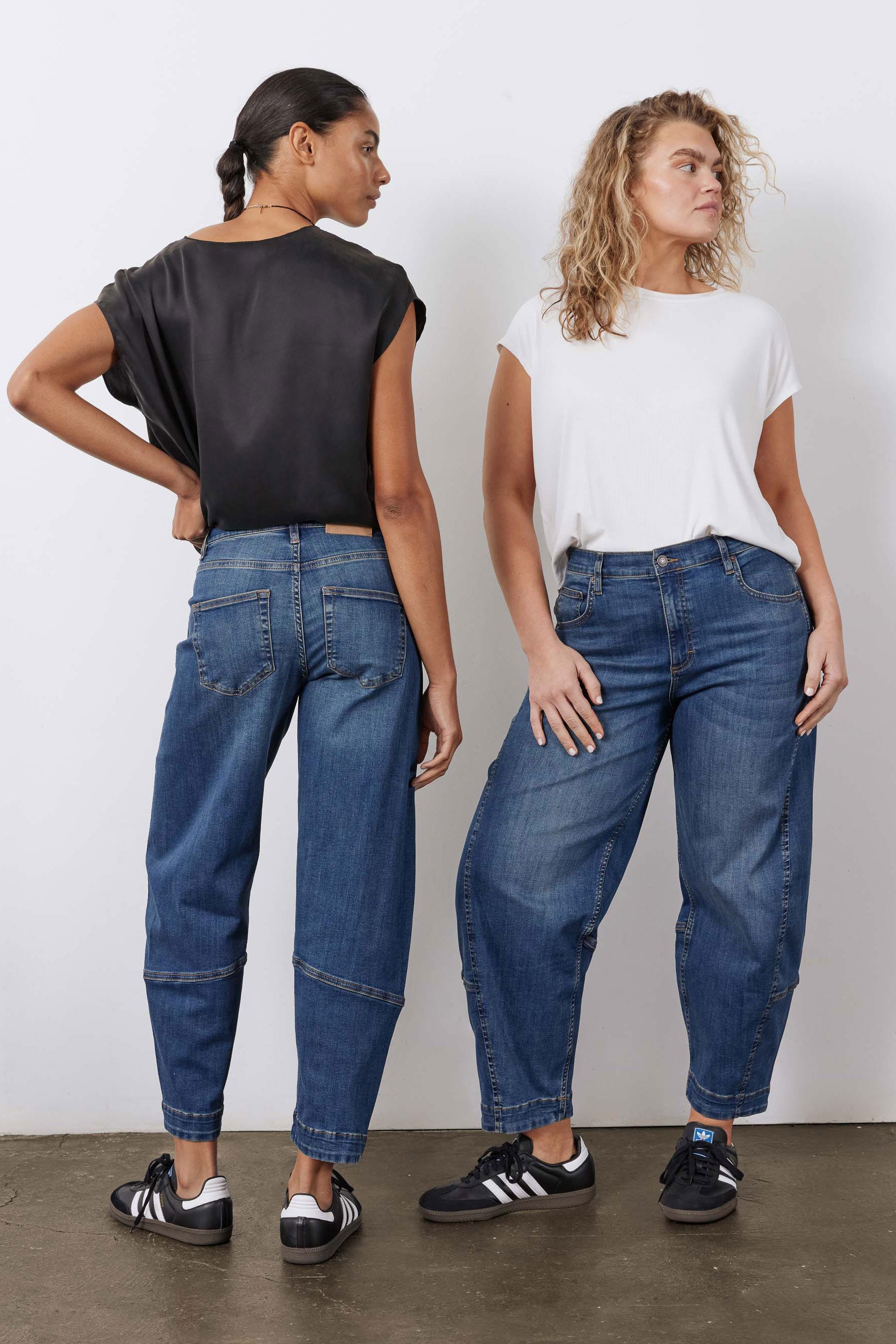 Indigo barrel-leg jeans shown from back and side, rolled cuffs and patch pockets