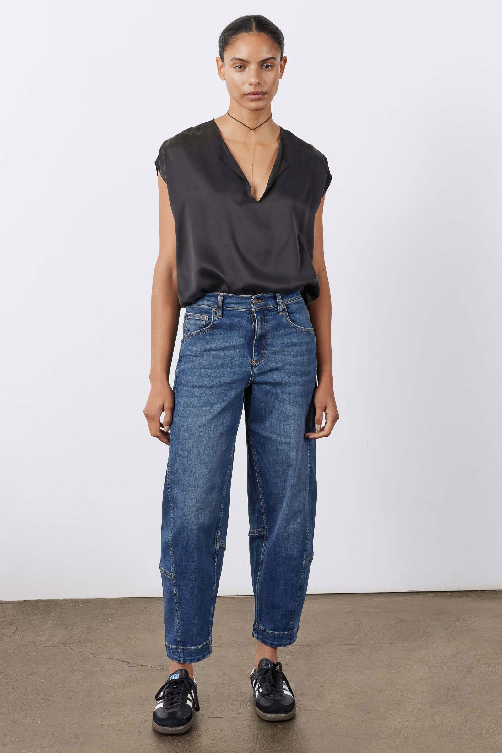 Indigo barrel-leg jeans with button fly, stitched seams, and cuffed hem