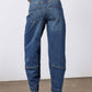 Indigo denim jeans with back yoke, patch pockets, and rolled cuffs