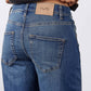 Indigo jeans back pocket with stitched patch pocket and waistband brand label