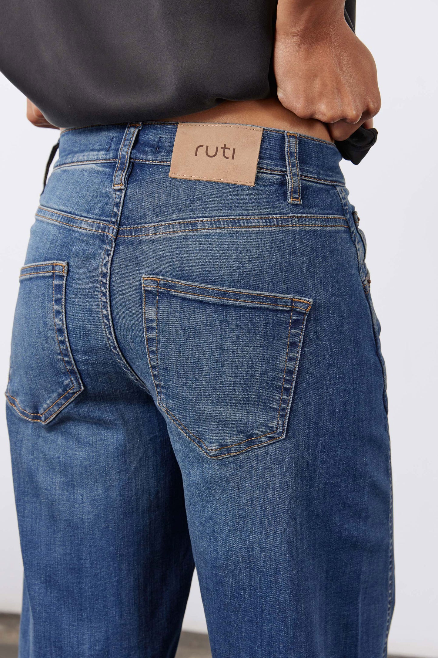 Indigo jeans back pocket with stitched patch pocket and waistband brand label