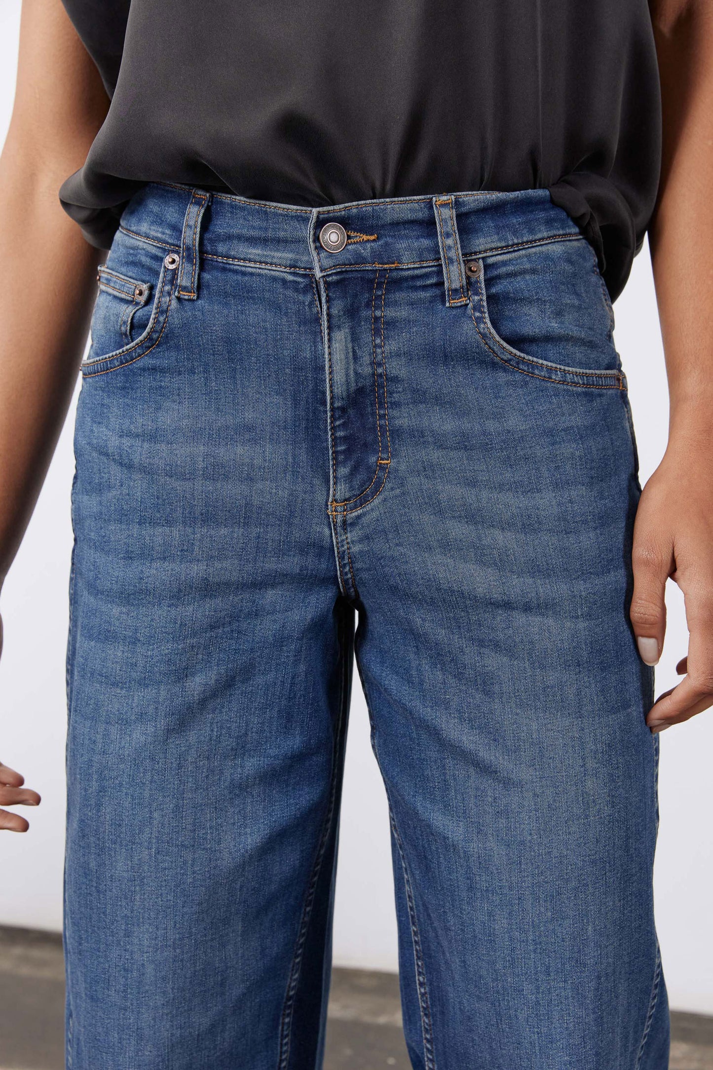 Indigo denim jeans waistband with button closure and belt loops